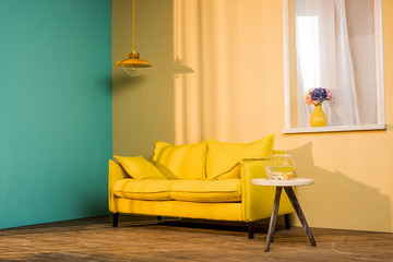 yellow sofa and aquarium on table in living room