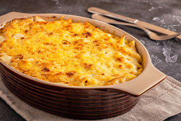 Mac and cheese, american style macaroni pasta in cheesy sauce.