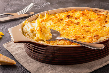 Mac and cheese, american style macaroni pasta in cheesy sauce.