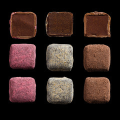 Set of handmade chocolate truffles isolated on black background