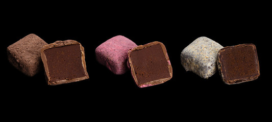 Set of handmade chocolate truffles isolated on black background
