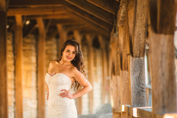 Wedding day. Gorgeous bride walking next to castle in west Ukraine.