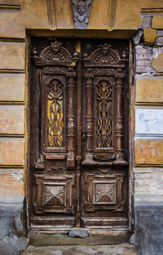 An ancient wooden door in the center of Rostov on Don. The historic door. Carved door with cracked paint