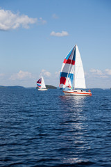 Fototapeta premium Two colorful sail on horizon on Lake Paijanne in Finland