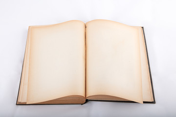 Vintage book, open, on white cloth