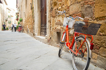 Fototapeta na wymiar Red bicycle stop beside the wall
