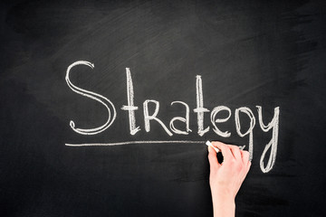 Hand writing Strategy underlined inscription on chalkboard