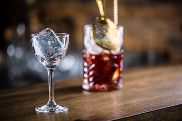 Manhattan cocktail drink decorated on bar counter in pub or restaurant.