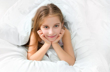 Obraz na płótnie Canvas child wrapped with a white blanket, awake