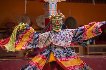 Unidentified monk in mask perform a religious masked and costumed mystery dance of Tibetan Buddhism...