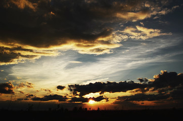 Sunset with clouds over the blue sky.