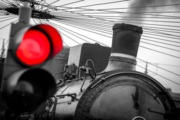 old train with red traffic light - black and white image