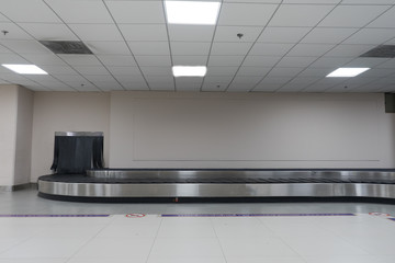Baggage conveyor belt in arrivals lounge of airport terminal