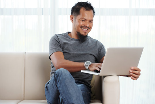 Filipino Cheerful Man With Laptop