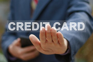 Businessman presses button credit card icon.