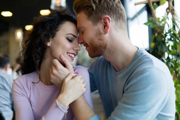 Young happy couple on date in coffee shop