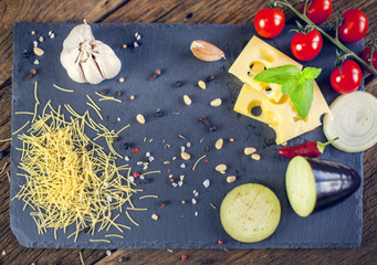  food cooking ingredients on dark background with , top view, Vegetables pasta and spices