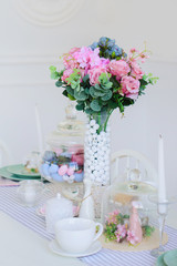 kitchen dining room with flowers and white furniture