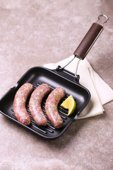 Raw homemade sausages with rosemary and lime