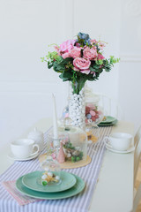 kitchen dining room with flowers and white furniture