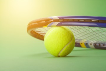 Tennis balls and rackets on grass
