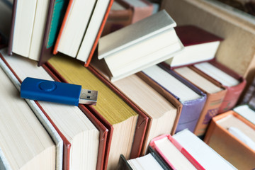 Memorization of knowledge books and organizer are near the blue stick on the table symbolizing. Stack books on wooden background. Back to school with copy space.