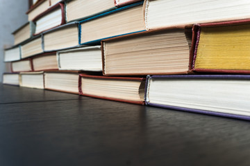 Stack books on wooden background. Back to school with copy space.