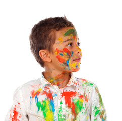 Funny boy with hands and face full of paint