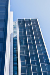 View of modern office building with blue glasses.