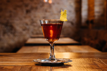 close-up view of sazerac cocktail in glass on wooden table