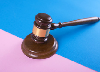 Judge gavel or auction on pink and blue background. Justice and auction.