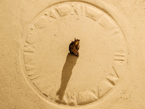 sun clock on sand