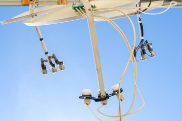A lot of satellite dishes mounted on the wall.