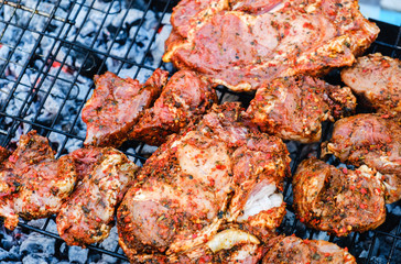 BBQ Roasted Pork Meat With herb spice On The Hot Charcoal Grill With Smoke.