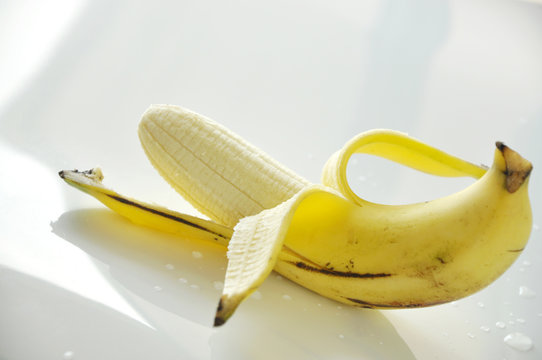 Close up Peeled Banana on White Background