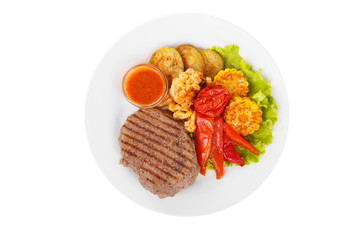 Steak beef, pork, lamb, grilled meat, barbecue with side dish vegetables on a plate isolated white background. Tomato, spicy, red sauce Juicy fillet, medium, strong roast. For the menu View from above