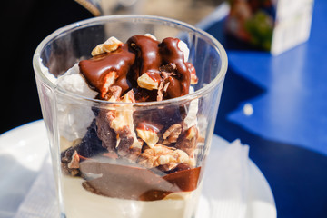 Bowl of chocolate ice cream on blue background.