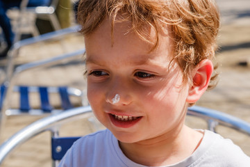 cute boy on a sidereal day at a cafe sits at table