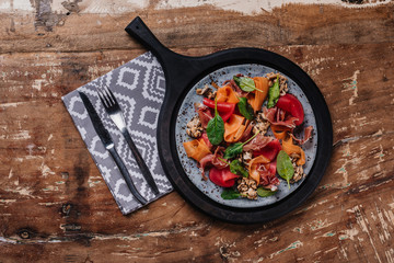 top view of delicious salad with mussels on wooden table