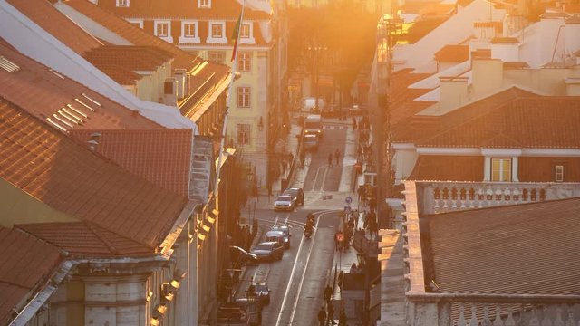 Lisbon, Portugal. Bridge, harbor and traffic on Rua do Arsenal in sunset lights. Tilt shot