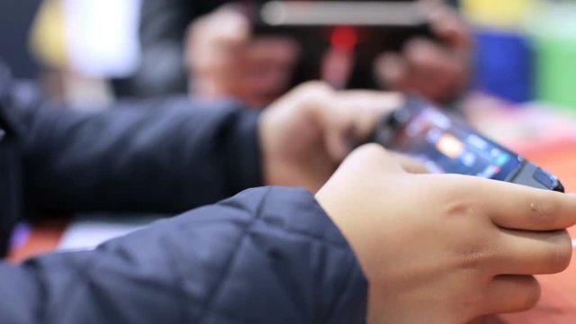 The guy plays on the game console-smartphone