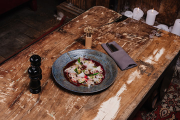 high angle view of fresh tasty Ceviche with dorado and daikon on wooden table in restaurant