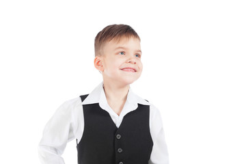 A preschool boy in a white shirt and black waistcoat smiles widely