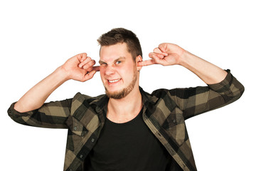 Fototapeta premium Young guy with beard and modern hairstyle mohawk, closing ears from noise, isolated on white background.