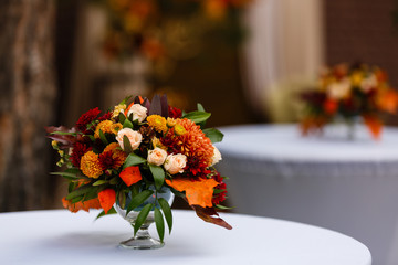autumn flower composition with roses, chrysanthemum and maple leaves