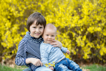 Adorable children, playing in the grass in park