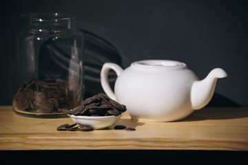 white ceramic teapot and chocolate