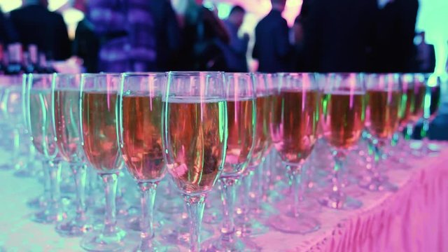 glasses with white sparkling wine in row at restaurant event