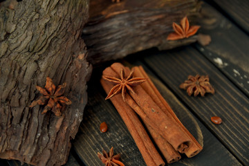 Close-up of star anise with cinnamon sticks on wooden table. Toned and art soft focus.