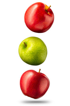 Falling red and green apples isolated on white background with clipping path and shiny reflections
